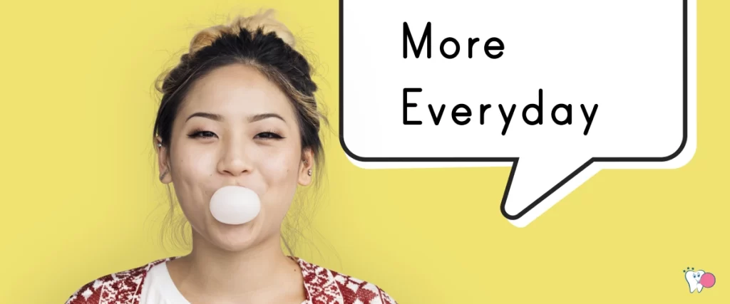 An Asian girl is blowing a chewing gum with a thought of 'More Everyday' against a yellow background | Source: shutterstock | For the article: Can Chewing Gum Improve Concentration? | For the website: healthchewinggum.com (Health Chewing Gum)