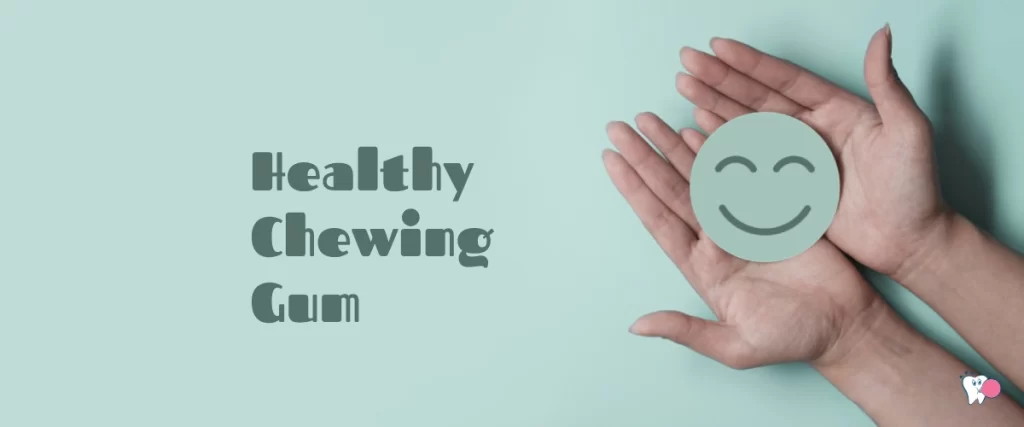 An image of two hands holding a happy smiley on a light green background with the text description "Healthy Chewing Gum", for the article: What is Healthy Chewing Gum, for the website: healthchewinggum.com | Health Chewing Gum, source: shutterstock.com